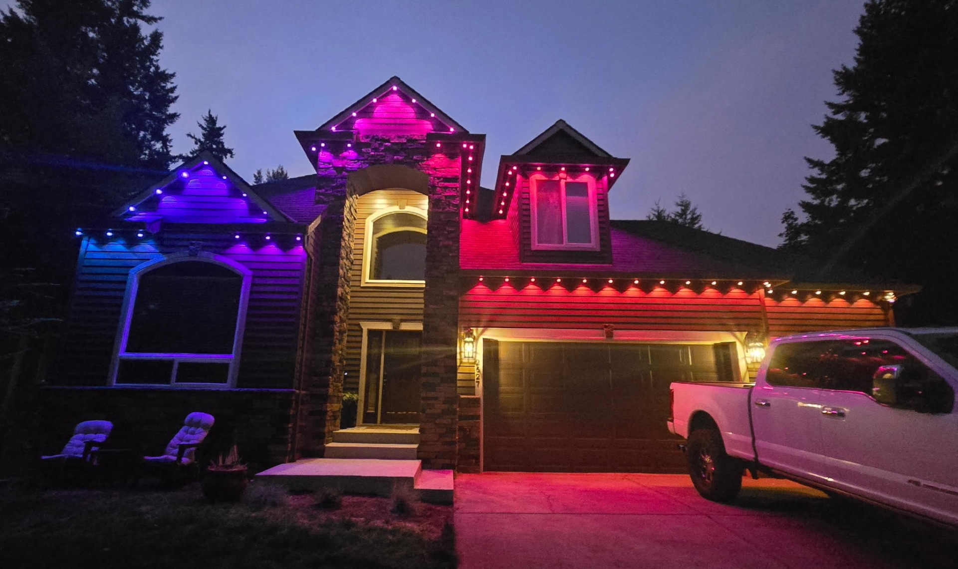 Govee permanent RGBIC lighting displaying multiple colors across roofline and eaves