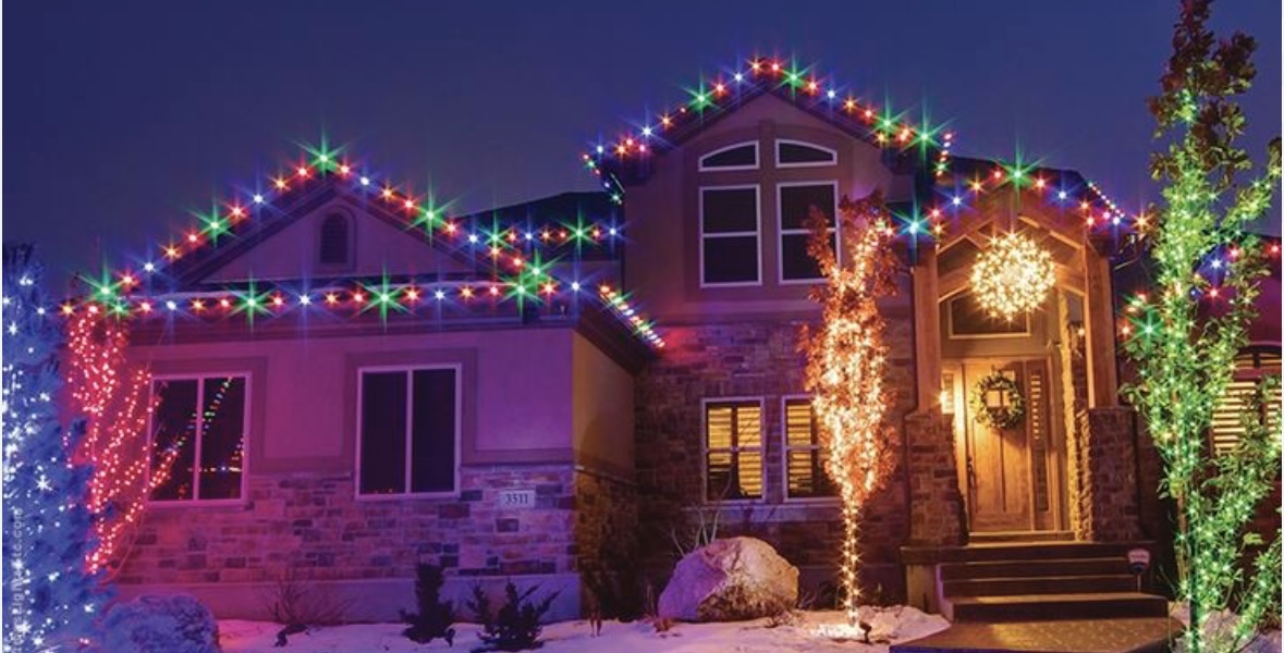Multicolor holiday lights with wrapped trees and entry accents
