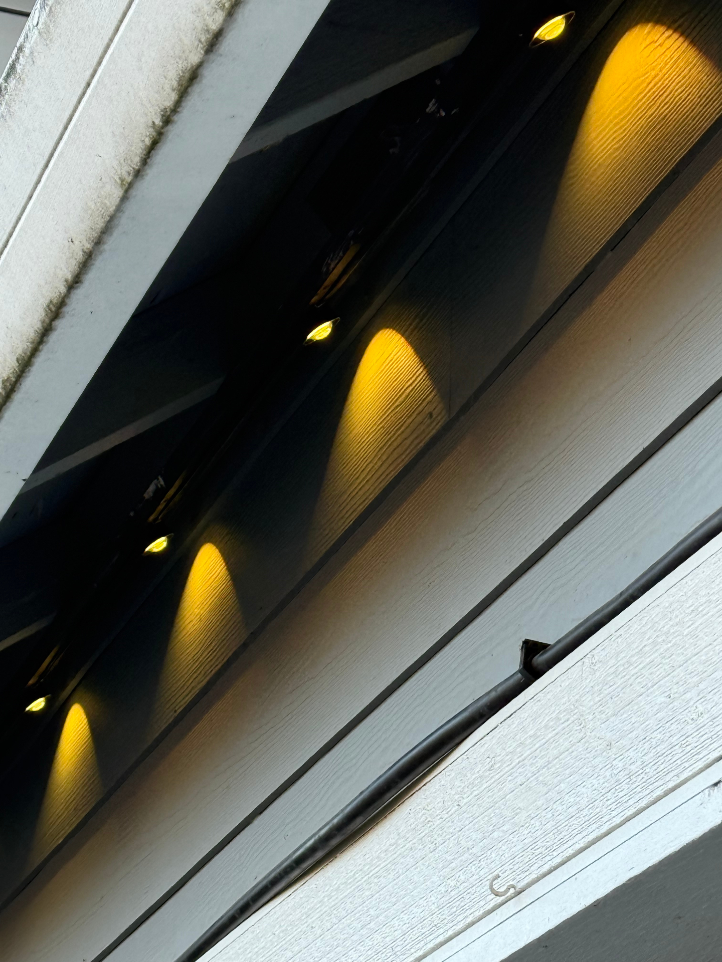 Close-up of discreet Govee permanent lighting track tucked under the eave